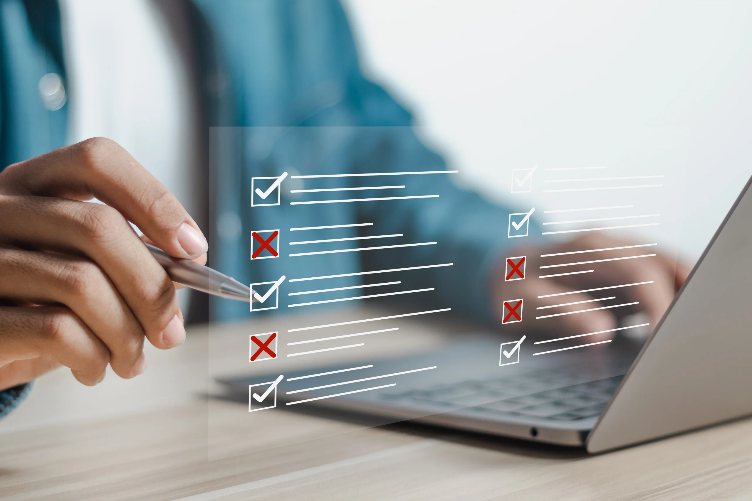 close-up of person on laptop with super imposed check boxes